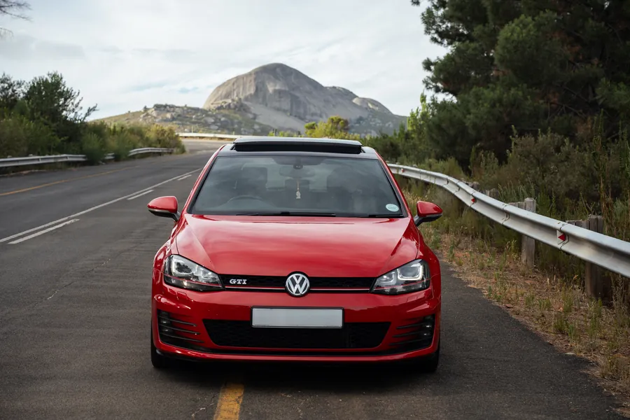 Red VW Golf 7 GTI on a mountain pass