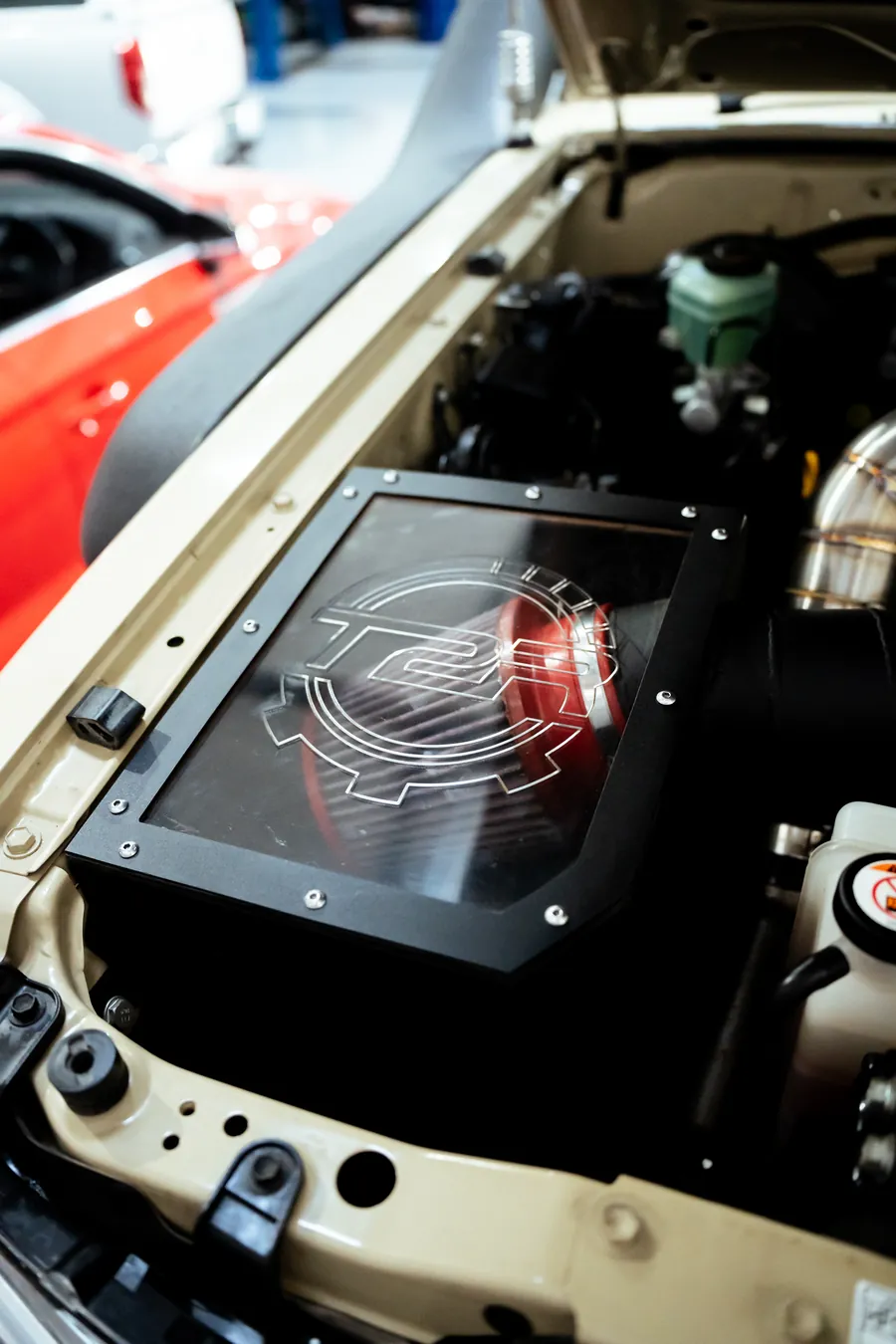 Airbox with a red filter under a clear cover