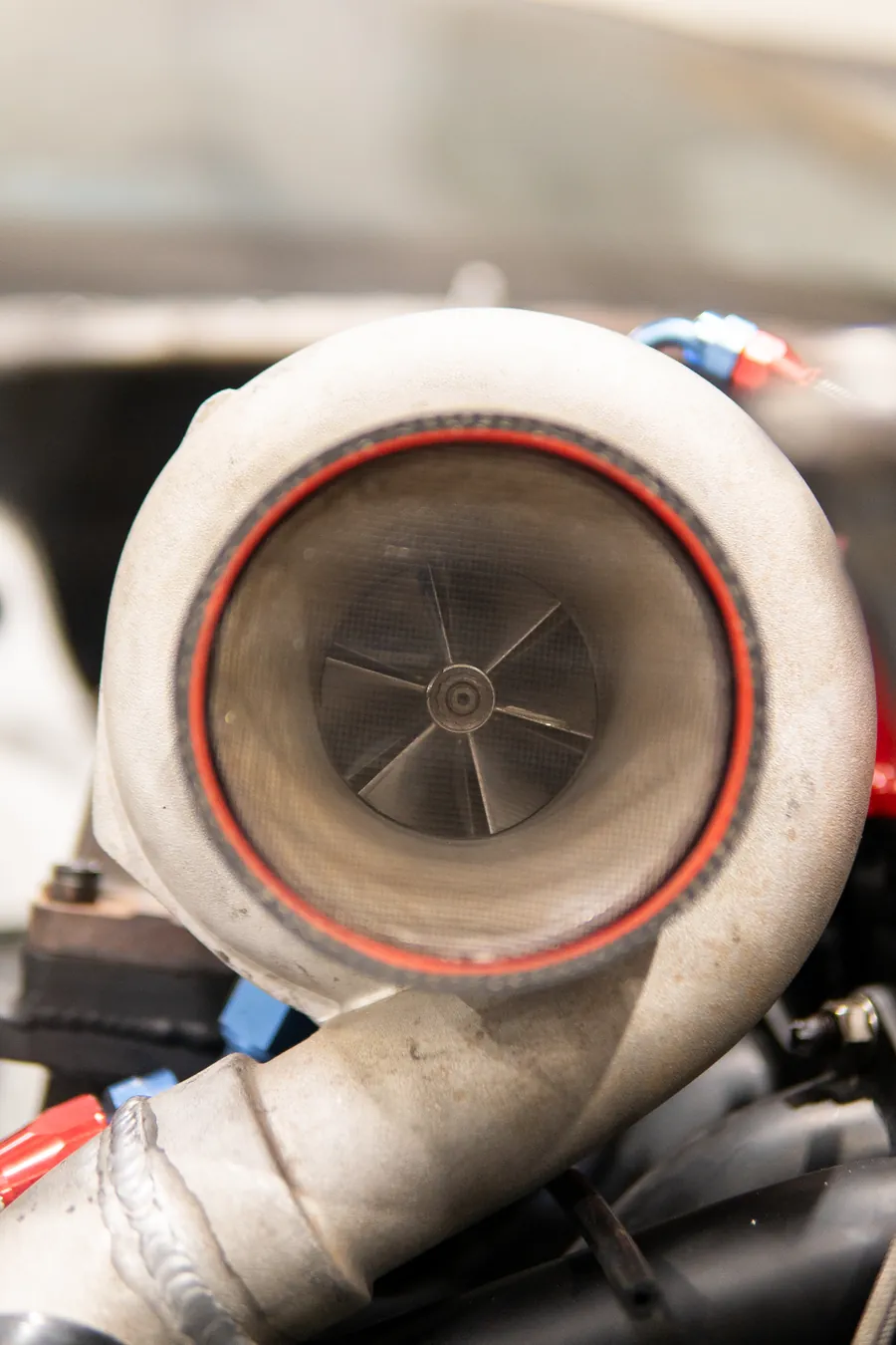 Close-up of a turbocharger compressor in an engine bay